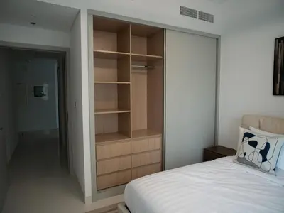 a bedroom with a built in closet and a bed at Marina Beachfront Oasis Infinity Pool & Modern Comfort in Dubai