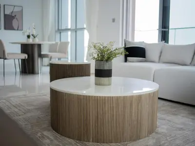 a living room with a coffee table and a couch at Marina Beachfront Oasis Infinity Pool & Modern Comfort in Dubai