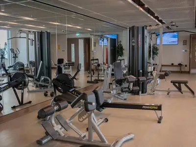 a gym with a lot of exercise equipment in it at Marina Beachfront Oasis Infinity Pool & Modern Comfort in Dubai