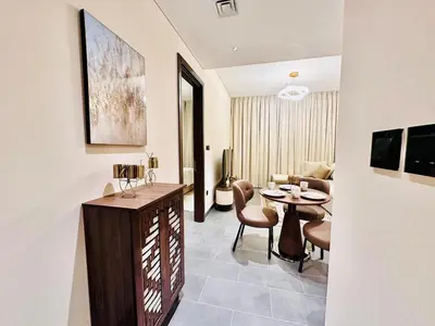 a living room with a table and a couch at Modern Fully Furnished 1BR plus Study in Crest Tower B in Dubai