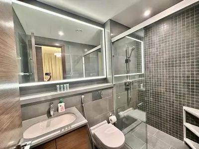 a bathroom with a sink and a mirror at Modern Fully Furnished 1BR plus Study in Crest Tower B in Dubai