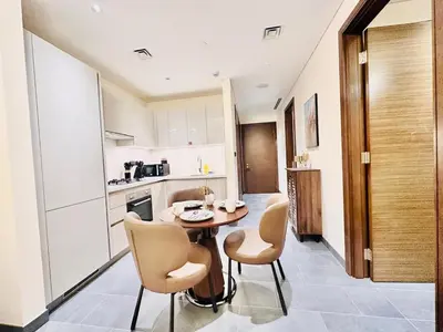 a kitchen with a table and chairs in a room at Modern Fully Furnished 1BR plus Study in Crest Tower B in Dubai