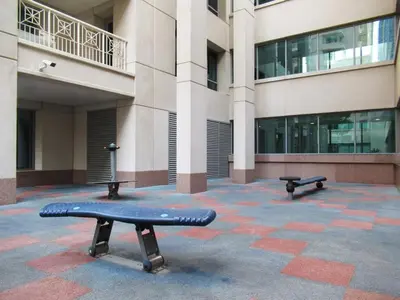 two benches sitting in front of a building at GuestReady - Downtown stay | 29 Boulevard in Dubai