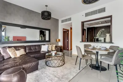 a living room with a couch and a table at GuestReady - Downtown stay | 29 Boulevard in Dubai