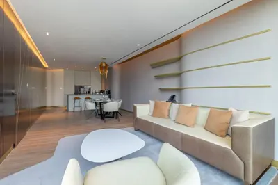 a living room with a couch and a table at The Opus Residences Luxury Design in Dubai