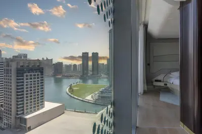 a bedroom with a view of a city at The Opus Residences Luxury Design in Dubai