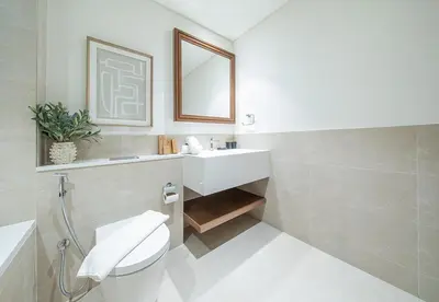 a bathroom with a toilet and a sink and a mirror at 1 Bed in Palace Beach Residence with sea view in Dubai