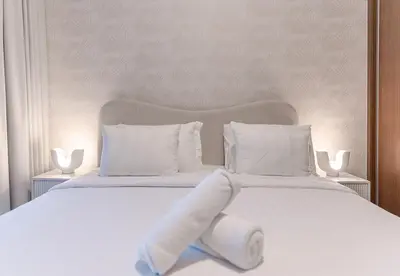a white bed with two white towels on it at 1 Bed in Palace Beach Residence with sea view in Dubai