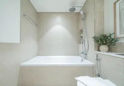 a bathroom with a tub and a toilet and a sink at 1 Bed in Palace Beach Residence with sea view in Dubai