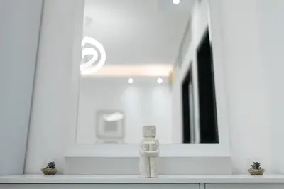 a wooden object sitting on a counter in front of a mirror at Dubai Marina - Comfy 1BHK Apartment in Dubai