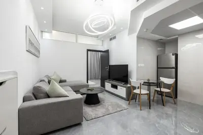 a living room with a couch and a table at Dubai Marina - Comfy 1BHK Apartment in Dubai