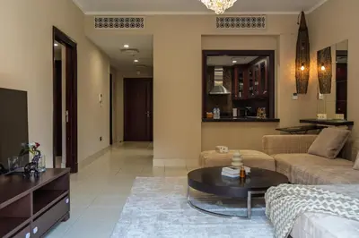 a living room with a couch and a table at Werova - Spacious 1-Bedroom Apartment for Rent in Dubai