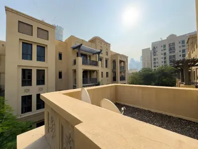 a balcony with a view of some buildings at Werova - Spacious 1-Bedroom Apartment for Rent in Dubai