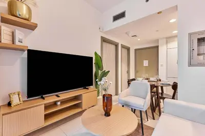 a living room with a large flat screen tv at Compact 1 BHK Apartment in Dubai