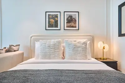 a bedroom with a white bed with two pillows at Stylish Studio in the Heart of DIFC in Dubai