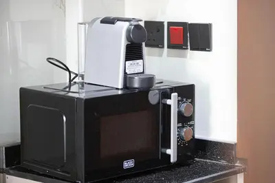 a microwave sitting on top of a counter at Stylish Silicon Oasis Studio Near Mall & Airport in Dubai