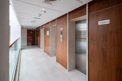 a row of elevators in a hallway in a building at Stylish Silicon Oasis Studio Near Mall & Airport in Dubai