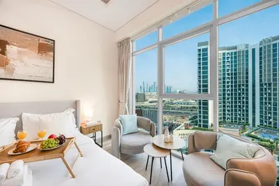 a hotel room with a bed and a large window at Livin' Holidays -Studio - Azizi Magnificent Studio in Dubai