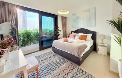 a bedroom with a bed and a large window at SKYLiNE - 4 BR - BURJ KHALiFA & FOUNTAiN ViEW in Dubai
