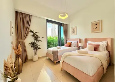 a bedroom with two beds and a large window at SKYLiNE - 4 BR - BURJ KHALiFA & FOUNTAiN ViEW in Dubai