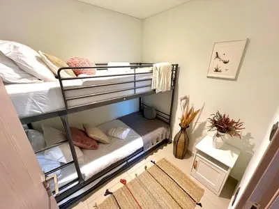 a bedroom with two bunk beds in a room at SKYLiNE - 4 BR - BURJ KHALiFA & FOUNTAiN ViEW in Dubai