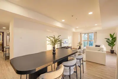 a living room with a large table and chairs at Central Spacious Marina Home on the 64th Floor in Dubai