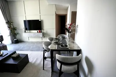 a living room with a dining table and chairs at Elegant 1BHK Sea View Apartment City View in Dubai