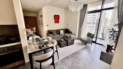 a living room with a table and a living room with a couch at Elegant 1BHK Sea View Apartment City View in Dubai