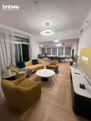a large living room with couches and a table at bnbmehomes - Burj Views East Tower in Dubai