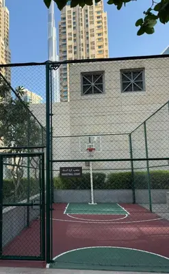 a tennis court with a net on a court at Elite Downtown 1BR Stylish 1BR in Dubai