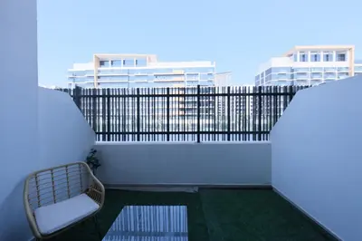 a balcony with a bed and a fence at Premium Studio near Meydan Azizi Riviera 46 in Dubai