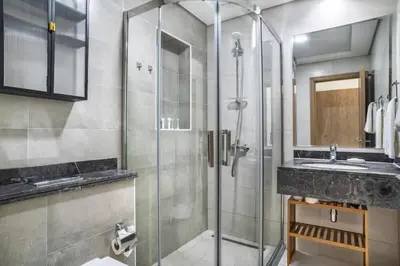 a bathroom with a glass shower and a sink at GuestReady – Business Bay Bliss | Near Dubai Mall in Dubai