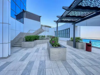 a building with stairs and potted plants on it at GuestReady – Business Bay Bliss | Near Dubai Mall in Dubai