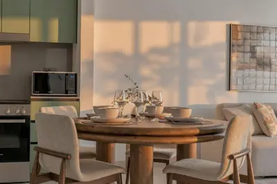 a dining room table with chairs and a table and a couch at 1 Bedroom Apartment in Central Park, City Walk in Dubai