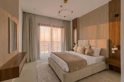 a bedroom with a large bed and a large window at 1 Bedroom Apartment in Central Park, City Walk in Dubai