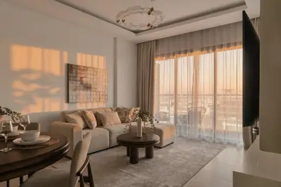 a living room with a couch and a table at 1 Bedroom Apartment in Central Park, City Walk in Dubai