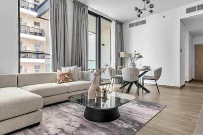 a living room with a couch and a table at GuestReady - 1BR l Elegant City Escape in Dubai