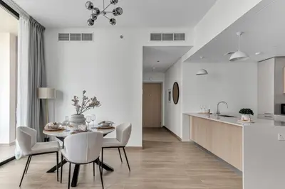 a kitchen and dining room with a table and chairs at GuestReady - 1BR l Elegant City Escape in Dubai
