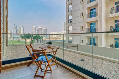 a table and chair on a balcony with a view at GuestReady - 1BR l Elegant City Escape in Dubai