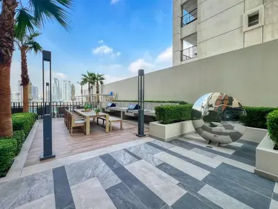 a patio with a table and chairs on a building at GuestReady - 1BR l Elegant City Escape in Dubai