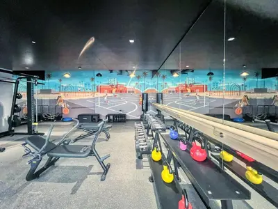 a gym with a ping pong table and chairs at GuestReady - 1BR l Elegant City Escape in Dubai
