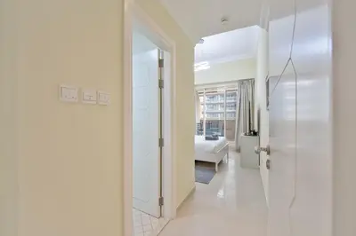 a hallway with a door leading to a bedroom at Marcopolo - Relaxing 1BR in Dubai Marina with Huge Balcony in Dubai