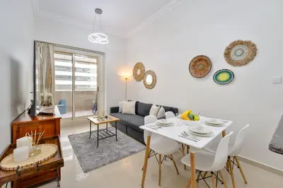 a living room with a table and a couch at Marcopolo - Relaxing 1BR in Dubai Marina with Huge Balcony in Dubai