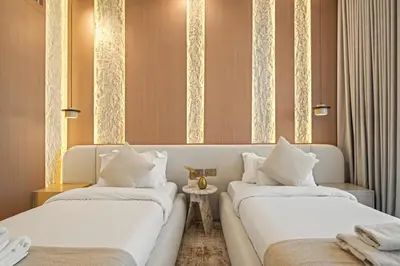 two beds with white pillows in a room at Serene Waterfront Gem UPSCALE in Dubai