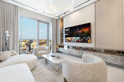 a living room with a flat screen tv on a wall at Serene Waterfront Gem UPSCALE in Dubai