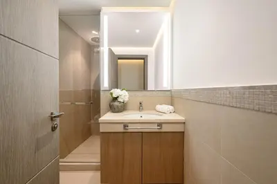 a bathroom with a sink and a mirror at Paradise Retreats 3BR Burj Khalifa & Fountain view in Dubai