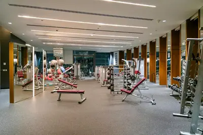 a gym with a lot of treadmills and machines at Paradise Retreats 3BR Burj Khalifa & Fountain view in Dubai