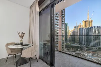 a balcony with a table and a view of a city at Stunning Studio With Burj Khalifa & Canal Views in Dubai