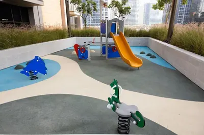 a small playground with a slide and a slideintend at Stunning Studio With Burj Khalifa & Canal Views in Dubai