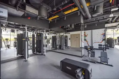 a gym with treadmills and machines in a room at Stunning Studio With Burj Khalifa & Canal Views in Dubai